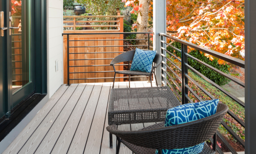 An outdoor deck with brown composite decking and black railings
